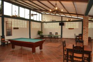 a pool table in a room with tables and chairs at El Virrey Hotel Boutique in Honda