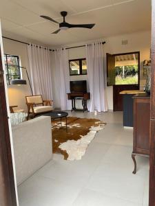a living room with a couch and a table at Luxury modern farm cottage with sea view in Southbroom