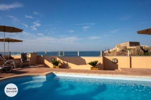 a swimming pool with a view of the ocean at Hotel Port Marine in Sète +64 photos