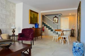 a living room with a table and chairs at Vila Toca in Funchal