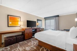 a hotel room with a large bed and a television at Comfort Inn Anaheim Resort in Anaheim