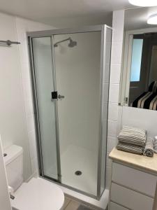 a bathroom with a shower with a toilet and a sink at Mooloolaba Magic at Beachclub Mooloolaba in Mooloolaba +10 photos