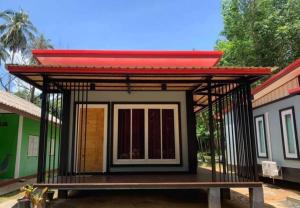 a small house with a red roof on top of it at Mimi Home in Ko Yao Noi