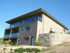 a large house with a stone wall at W21 in Great Brak River