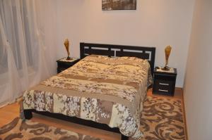 a bedroom with a bed and two night stands at Raduga 514 in Zatoka