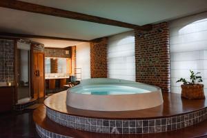 韦尔维耶Baiser de Cupidon的砖墙房间内的热水浴缸