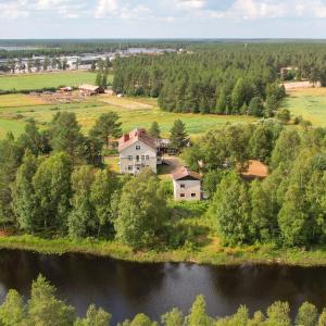 an aerial view of a house next to a lake at Staycation Törrö Sellivahti as 2 in Pudasjärvi +9 photos