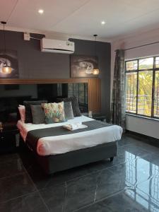 a bedroom with a large bed in a room at Bothabelo Bed and Breakfast in Phalaborwa +64 photos