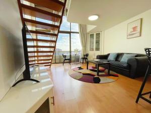 a living room with a couch and a table at Super Darling Harbour View in Sydney