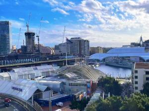 a view of a city with a river and buildings at Super Darling Harbour View in Sydney