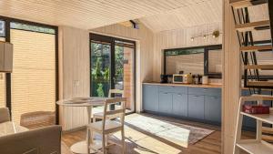 a kitchen and dining room with a table and chairs at Nordic Dream Chalet in Buşteni