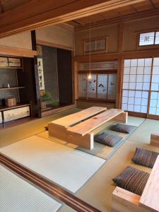 a large room with a table and mats on the floor at mokumoku 山 ishioka in Mooka