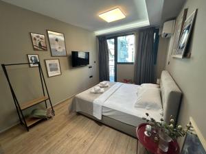 a small bedroom with a bed and a window at Dragoumi Suites Lydia in Thessaloniki