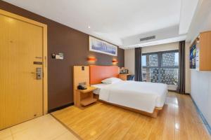 a bedroom with a white bed and a large window at 7Days Premium Chongqing Jiangbei International Airport Rongchuang in Chongqing +212 photos