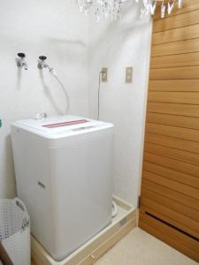 a white bathroom with a shower and a toilet at Ueda Building - Vacation STAY 8565 in Asahikawa