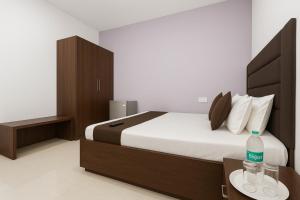 a bedroom with a bed with a bottle of water on a table at Pariksh!t's Rental Apartments in Calangute +5 photos