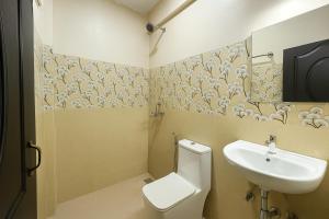 a bathroom with a toilet and a sink at Pariksh!t's Rental Apartments in Calangute