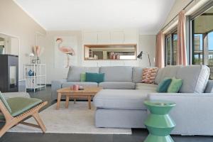 a living room with a couch and a table at Luxe Villa met Uitzicht 4p - Luxe, Rust & Water - Villa 67 in Ouddorp +55 photos