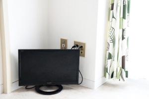 a flat screen tv in a corner of a room at Ueda Building - Vacation STAY 8555 in Asahikawa
