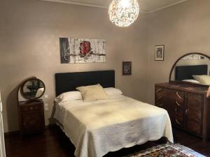 a bedroom with a bed and a mirror and a chandelier at Beb la terrazza in Iesi