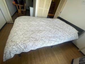 a bed with a white comforter in a bedroom at Ueda Building - Vacation STAY 8556 in Asahikawa