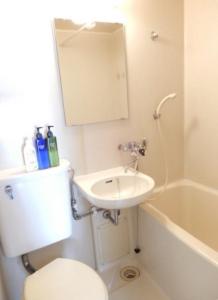a bathroom with a toilet and a sink and a tub at Ueda Building - Vacation STAY 8556 in Asahikawa
