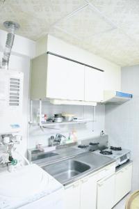 a kitchen with a sink and white cabinets at Ueda Building - Vacation STAY 8554 in Asahikawa +36 photos