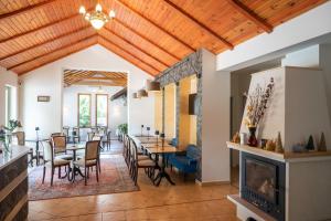 a dining room with a fireplace and tables and chairs at Boutique Hotel LuDo in Makó