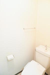 a white bathroom with a toilet and a sink at Ueda Building - Vacation STAY 8562 in Asahikawa