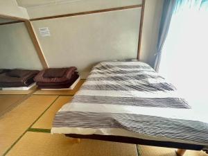 a large bed in a room with a window at Ueda Building - Vacation STAY 8566 in Asahikawa