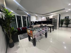 a living room with a stove in the middle of it at Villas In Pattaya in Jomtien Beach