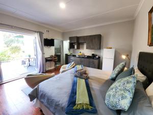 a bedroom with a large bed with pillows on it at Homestead Bed and Breakfast - Travel Addo Group in Addo