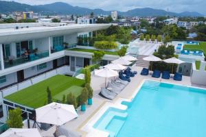 an image of a hotel with a pool and umbrellas at Chalong Marina Bay View Phuket in Rawai Beach
