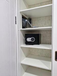 a microwave sitting on a shelf in a kitchen at 1кімнатна квартира Поляна, Грін Парк, 2 поверх in Polyana