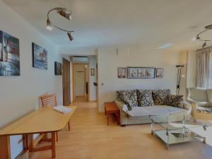 a living room with a couch and a table at Apartamentos Terrasol BARCO 5 in Torre del Mar