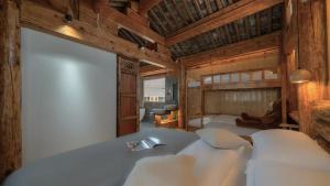 a bedroom with a bed and a bunk bed with a sink at Nostalgia 28 lodge in Baisha