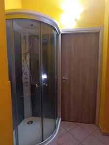 a shower with a glass door in a room at Casetta vacanze Gonnesa in Gonnesa