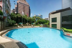 a large swimming pool in the middle of a city at Evergreen Laurel Hotel - Taichung in Taichung