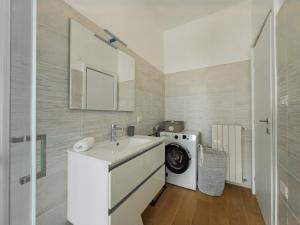 a bathroom with a sink and a washing machine at Lakeview Holiday Homen - Renovated apartment in the heart of Lovere with WiFi in Lovere +4 photos