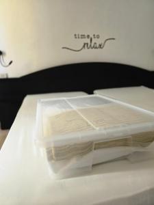 a plastic container sitting on top of a bed at Hotel Istria in Trieste