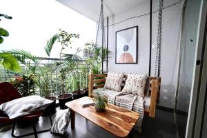 a living room with a couch and a table at Modern Luxe 2BHK Pune in Pune