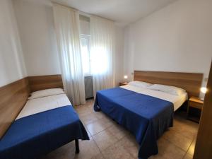 Ένα ή περισσότερα κρεβάτια σε δωμάτιο στο Villa Mazzon Family Apartments