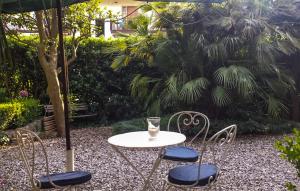 a table with two chairs and an umbrella at 2 Bedroom Gorgeous Home In Cava De' Tirreni in Cava deʼ Tirreni