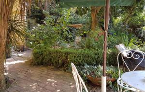 a patio with a table and chairs and an umbrella at 2 Bedroom Gorgeous Home In Cava De' Tirreni in Cava deʼ Tirreni +23 photos