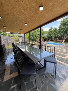a large dining table with chairs and a large window at Amora Guesthouse in Ashtarak +34 photos