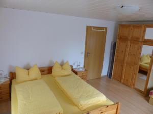 a bedroom with two beds with yellow pillows at Apartment view of fortress in Pirna in Pirna