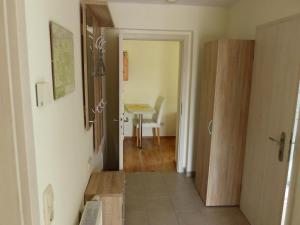 a hallway with a door to a room with a table at Apartment view of fortress in Pirna in Pirna