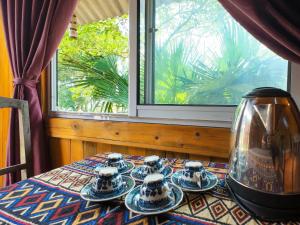 a table with plates and a vase on top of it at Giay's Local House in Sapa +81 photos