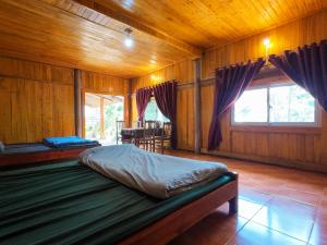 a bedroom with two beds in a wooden room at Giay's Local House in Sapa