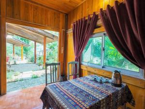 a dining room with a table and a window at Giay's Local House in Sapa